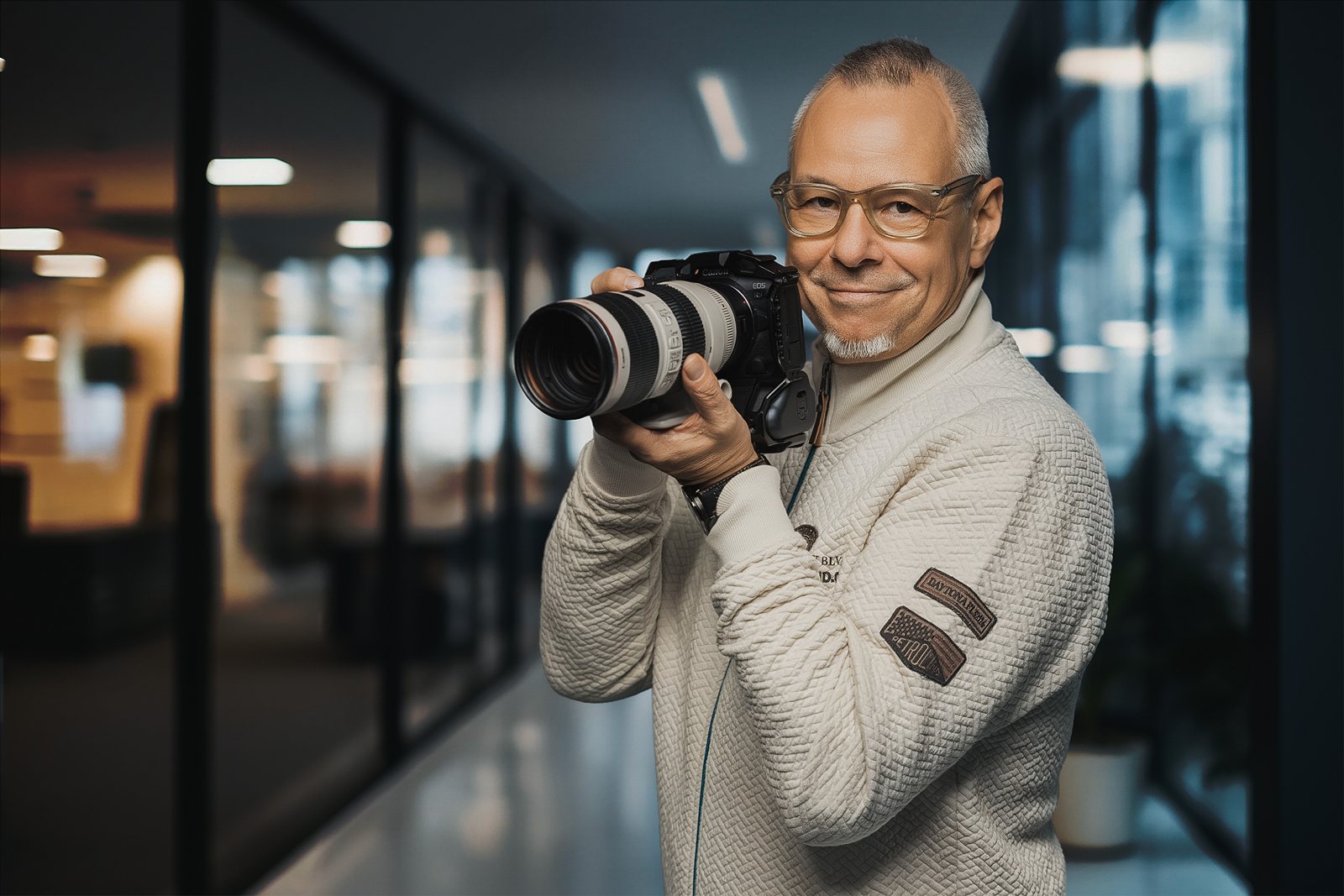 Andreas Schmitt mit Fotokamera in einem Bürogebäude